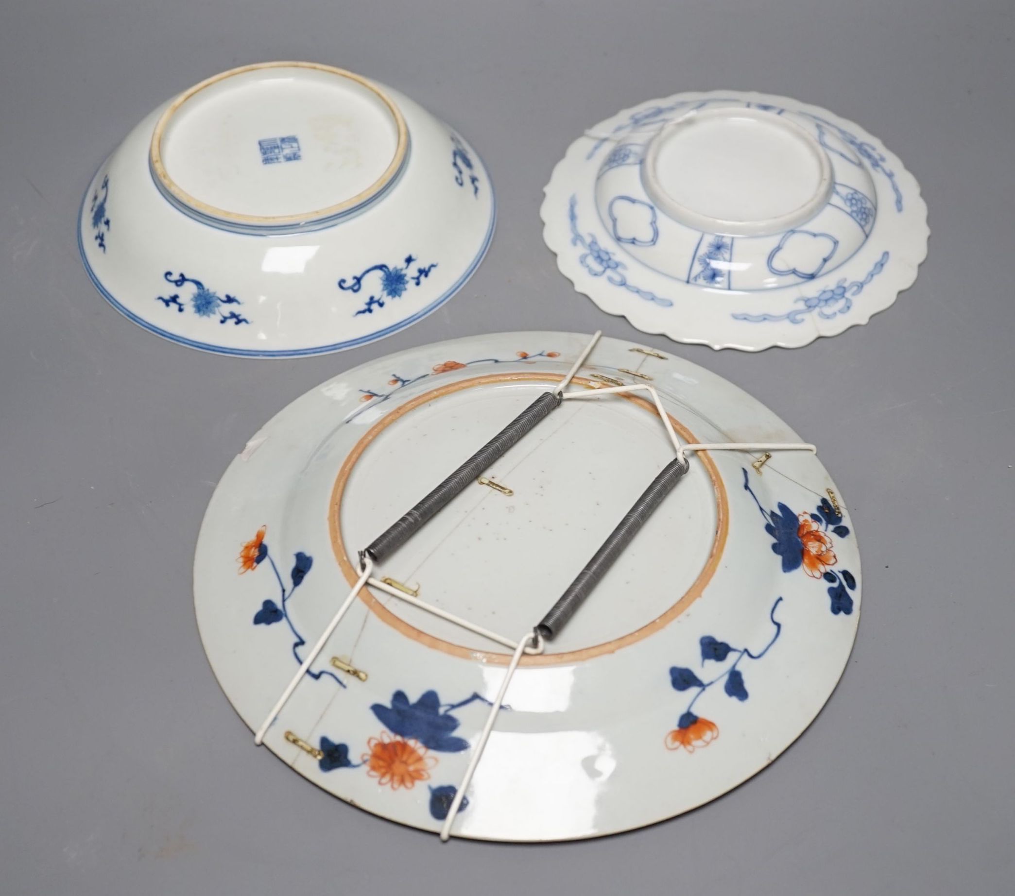 Three Chinese plates including a 19th century Chinese Imari dish, 23cm - repaired, a Chinese famille rose crackleglaze vase, 29cm, together with a famille rose teapot and a crackleglaze celadon ground bottle vase. Talles